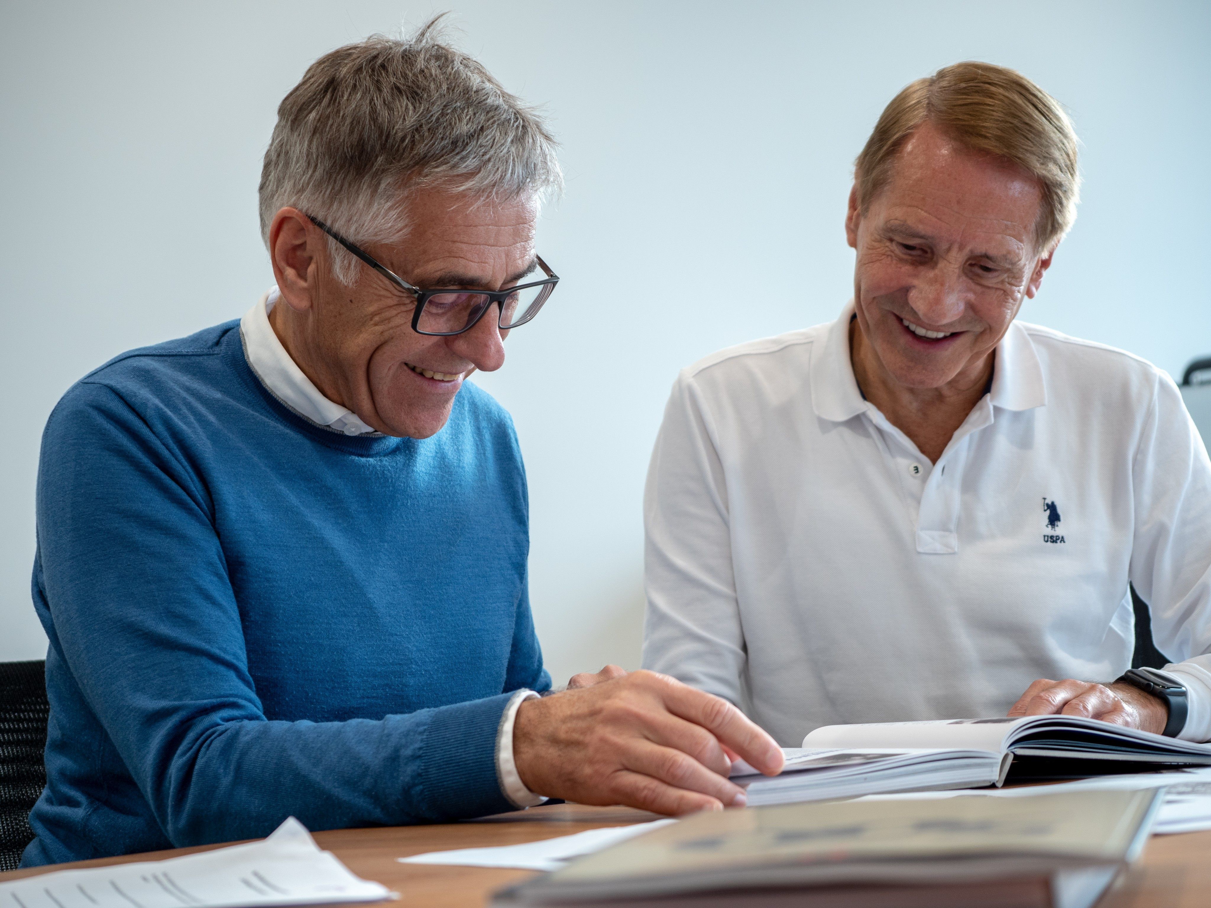 Karl und Michael Loacker mit dem firmeneigenen Geschichtsbuch.
