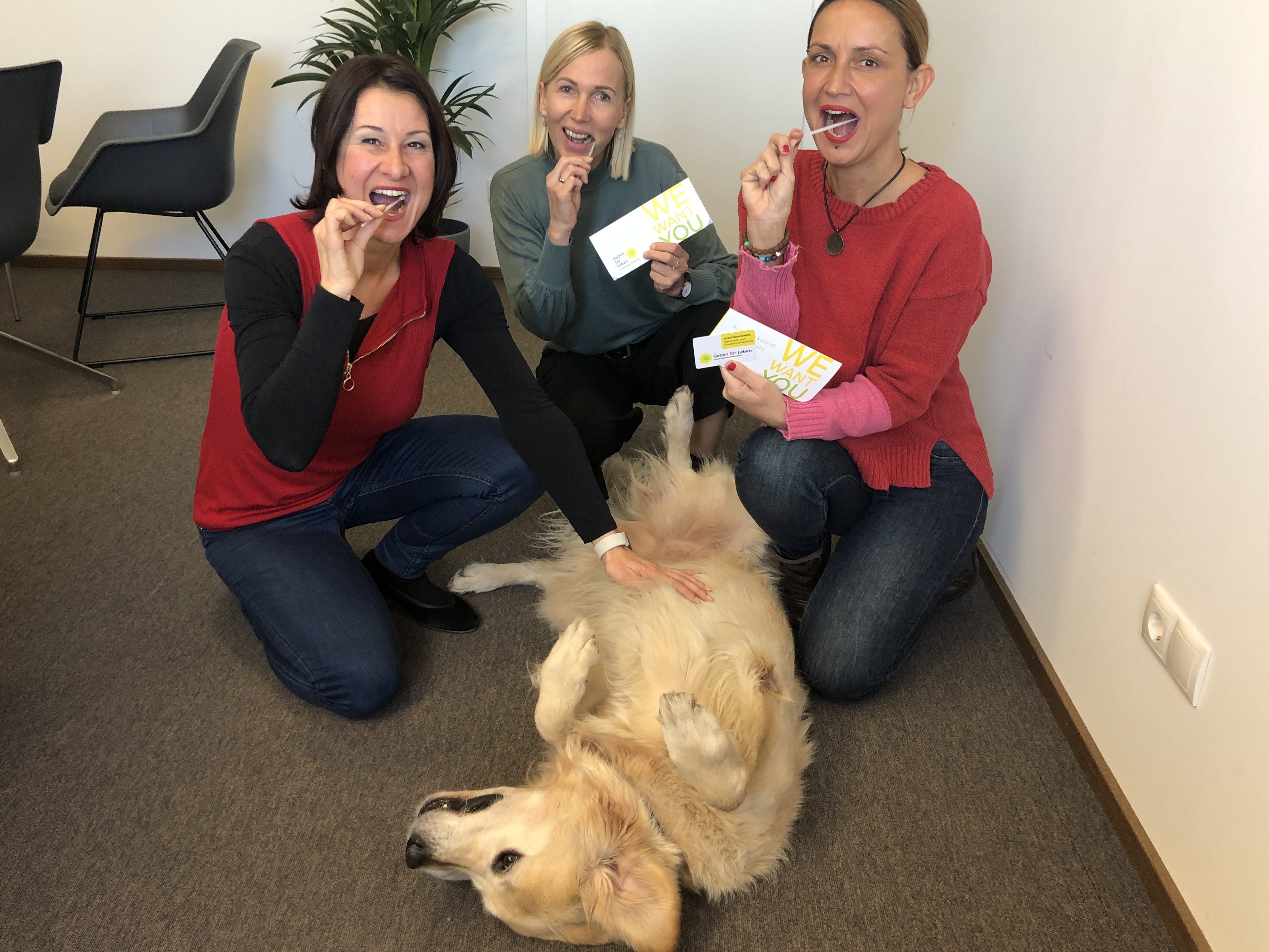 Mitarbeiterinnen Susanne Marosch, Monika Schöpf und Cemanur Kartal zusammen mit Wachhund Happy beim Wangenabstrich.