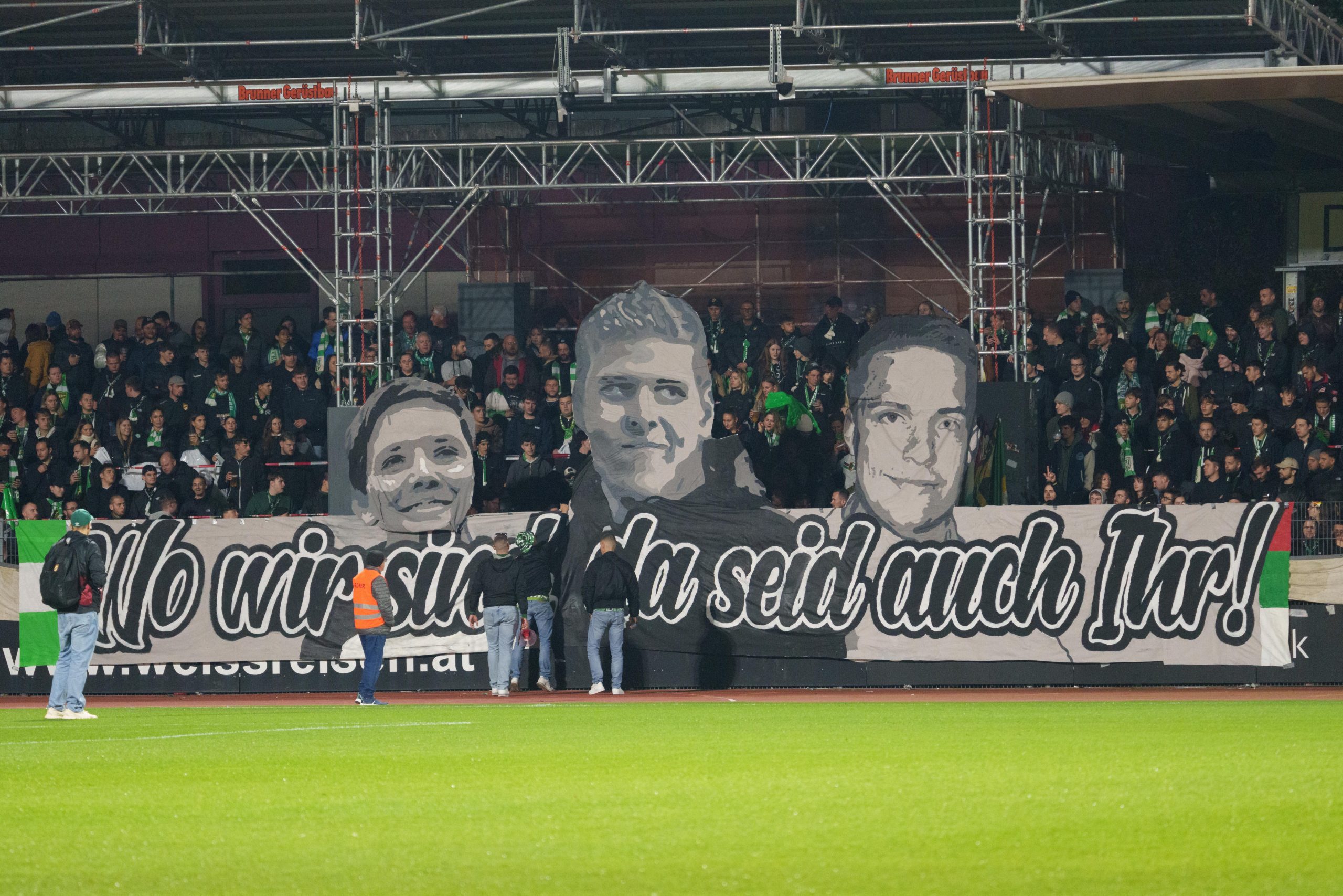 Beim Match SW Bregenz gegen Austria Lustenau am vergangenen Samstag erinnerte ein Banner an Simon (Mitte) und zwei weitere verstorbene Fans (r. und l.) aus Augsburg, welche bei einem Autounfall vor mehreren Jahren ums Leben kamen.