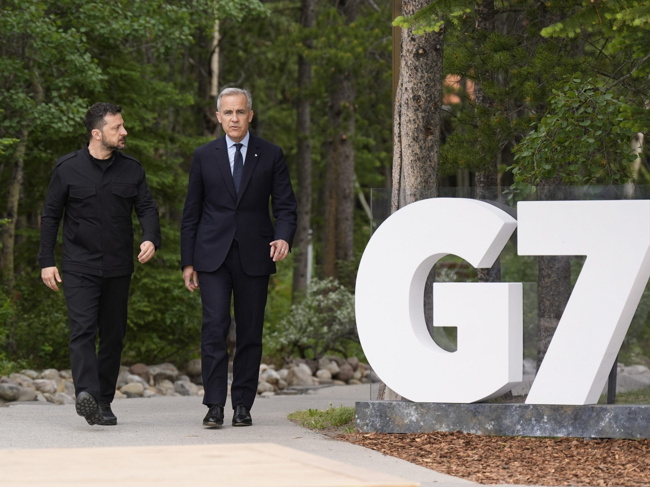Der kanadische Premierminister Mark Carney geht gemeinsam mit dem ukrainischen Präsidenten Wolodymyr Selenskyj zu einer Sitzung beim G7-Gipfel in Kananaskis, Alberta (Kanada).