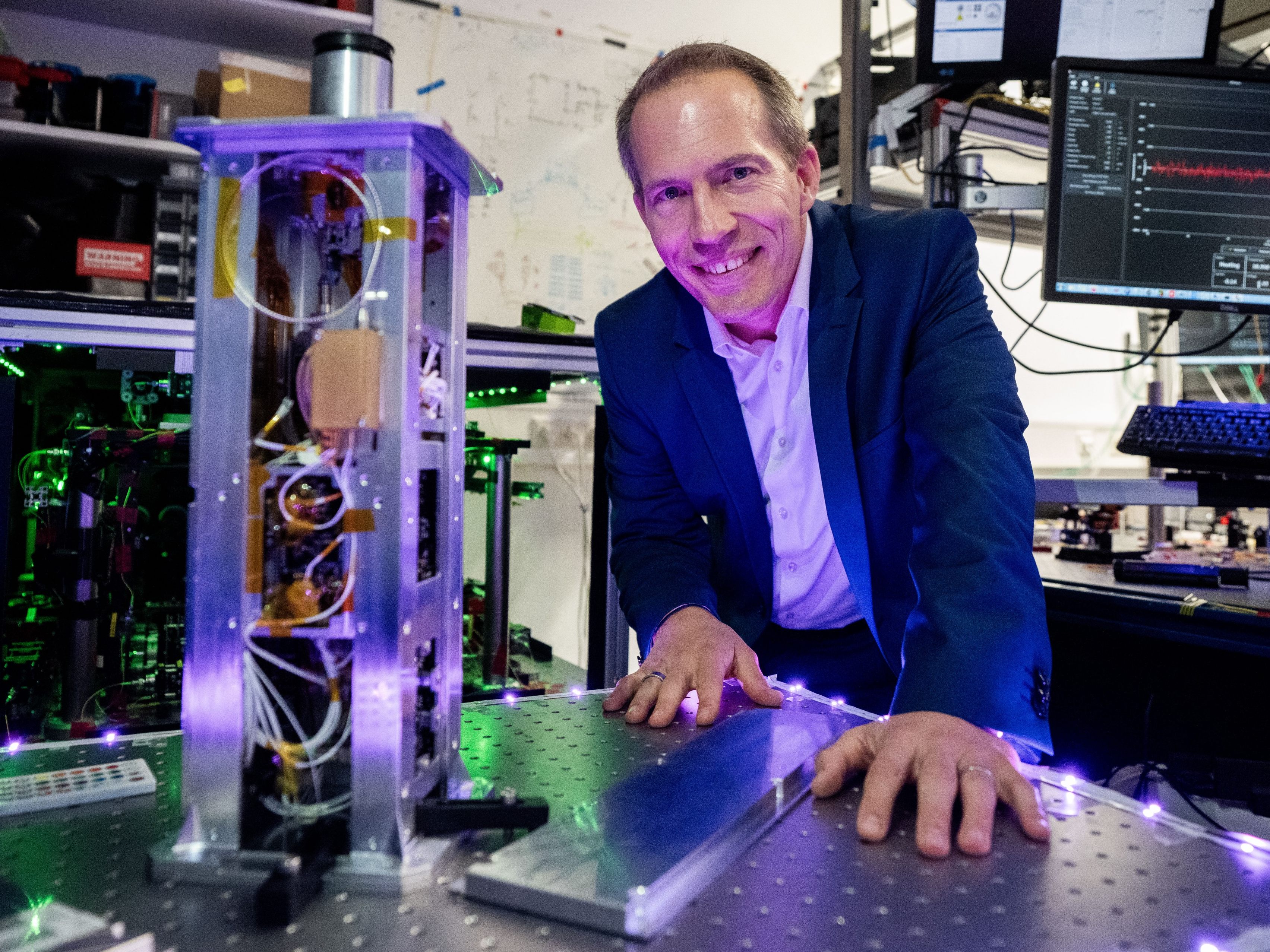 Quantenphysiker Philip Walther mit einem photonischen Satelliten-Quantencomputer an der Uni Wien.
